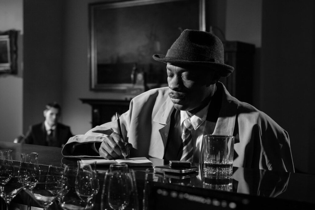 man writing at a bar